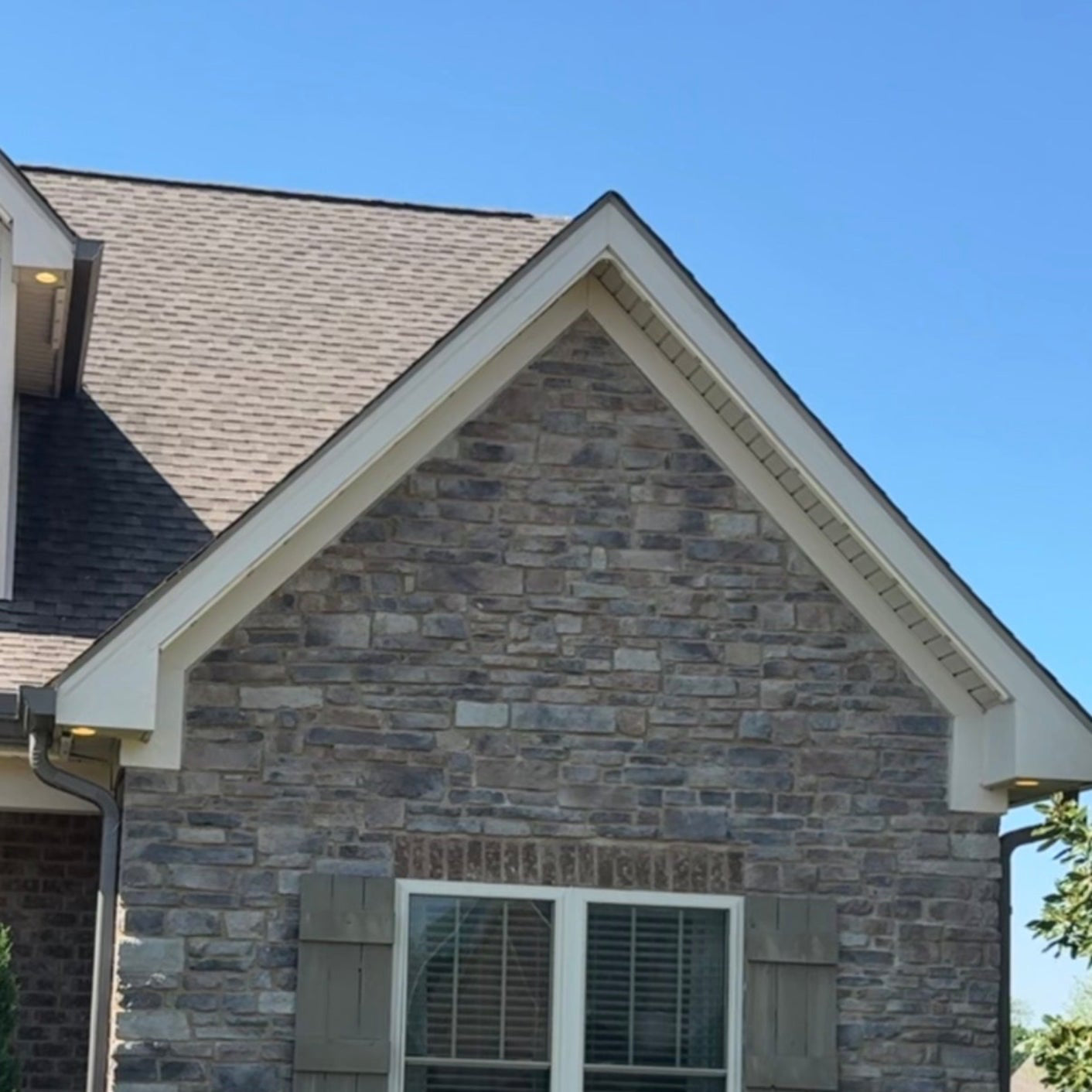 Daytime gable peak with track installed — virtually invisible from the street